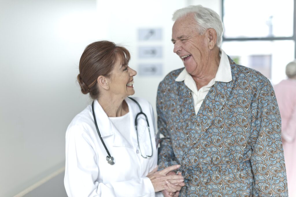 Doctor with happy elderly patient on hospital 